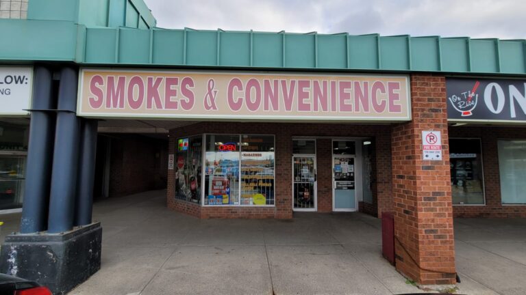 Storefront of Smokes and Convenience