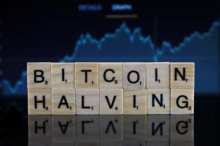 bitcoin halving concept spelled with letter blocks in front of crypto price chart
